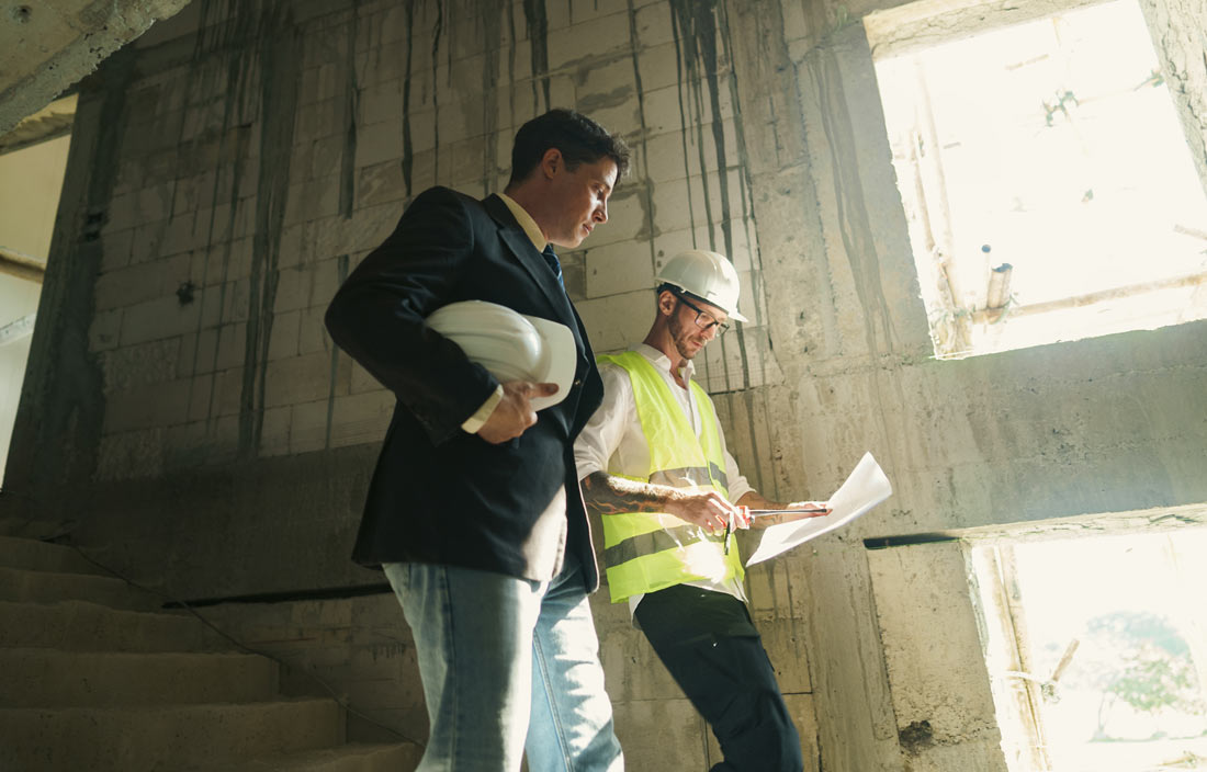 Construction professionals walking down a stairwell.