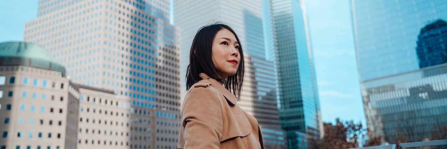 Person looking to the distance in the middle of a city.