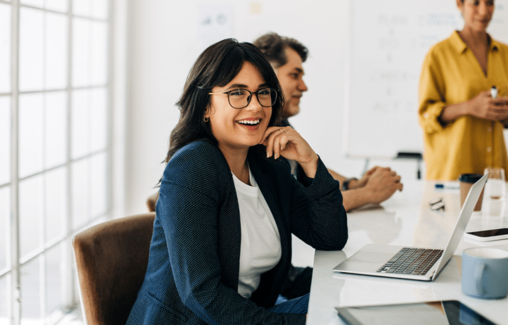 Nonprofit professional smiling at their desk.