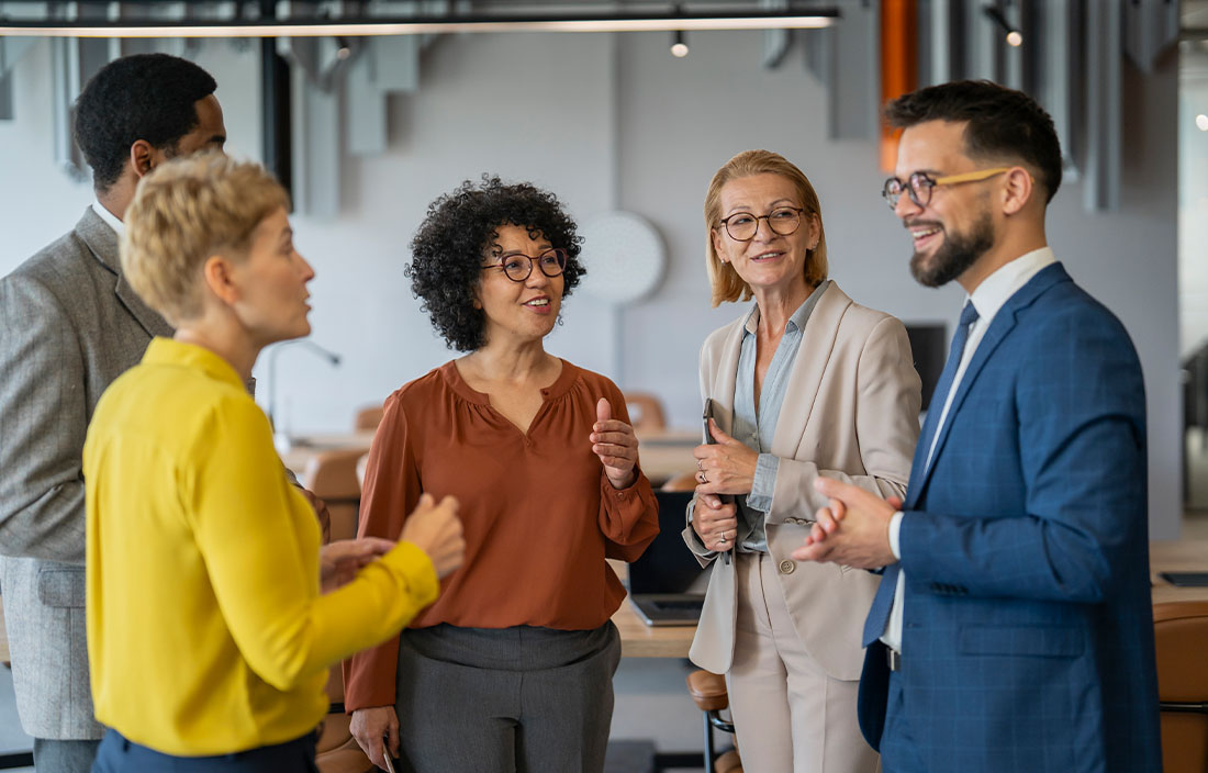 Group of coworkers mingling at a happy hour.