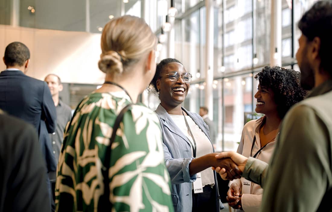Business professionals shaking hands at a conference