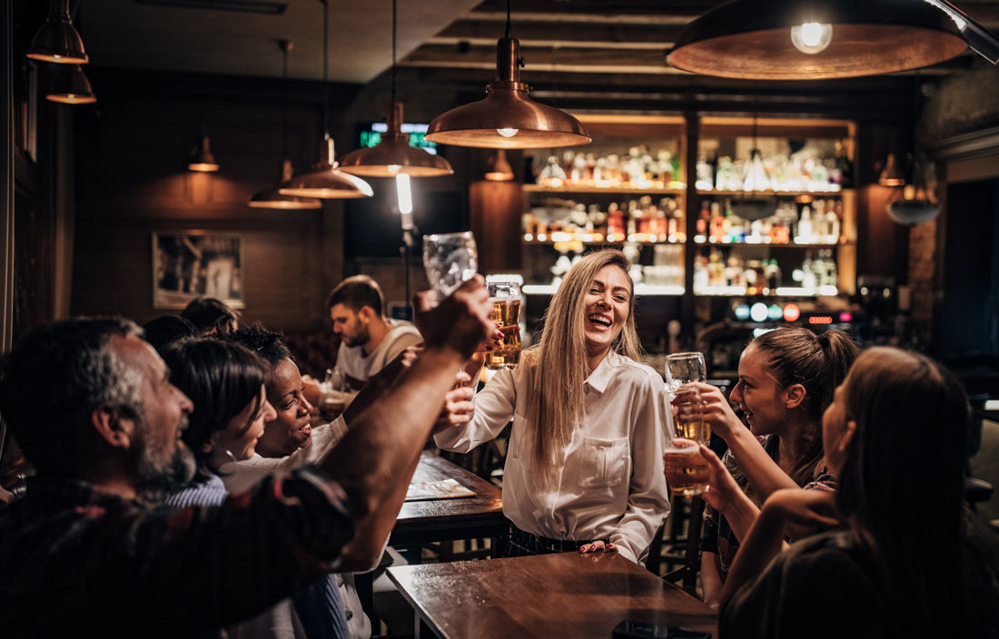 Group of people celebrating at a bar.