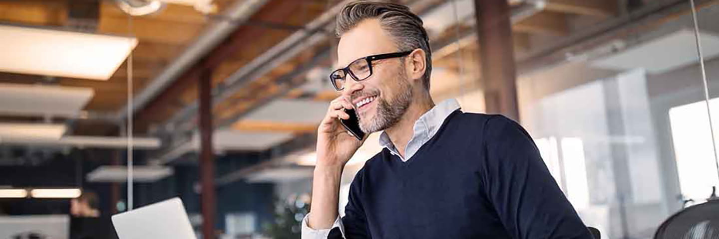 Business professional taking a phone call on a cell phone.