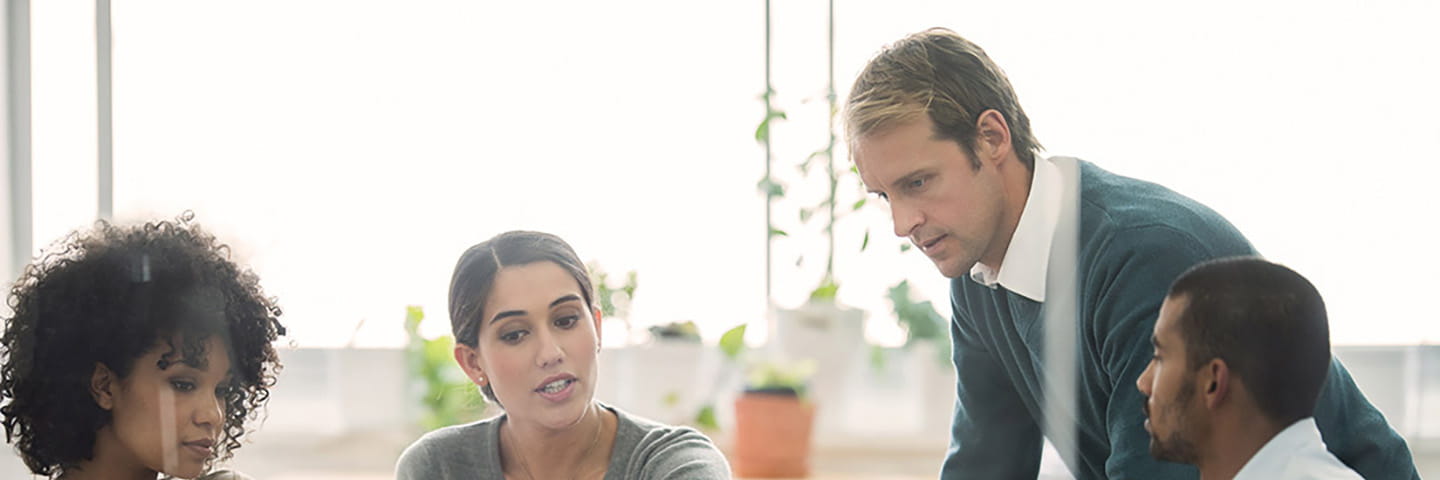 A group of business professionals discussing with one another.