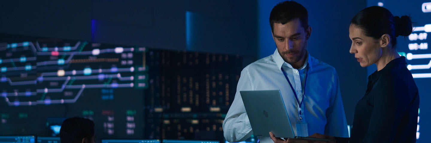 Two business professionals looking at a laptop