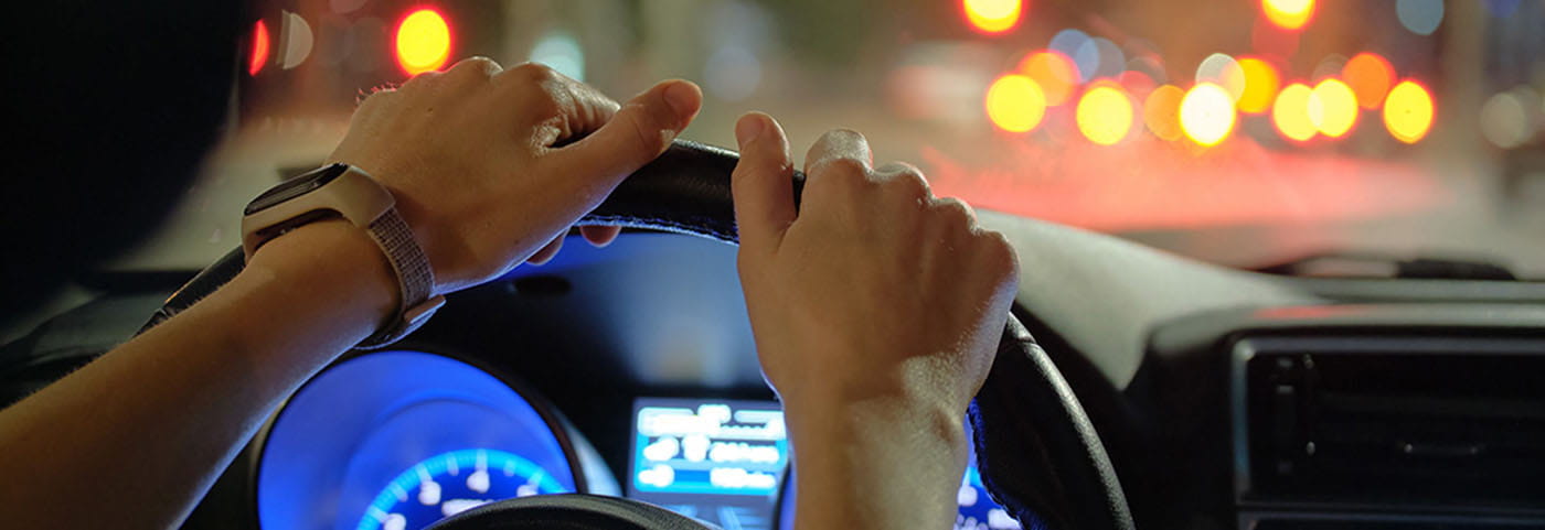 Hands on a steering wheel.