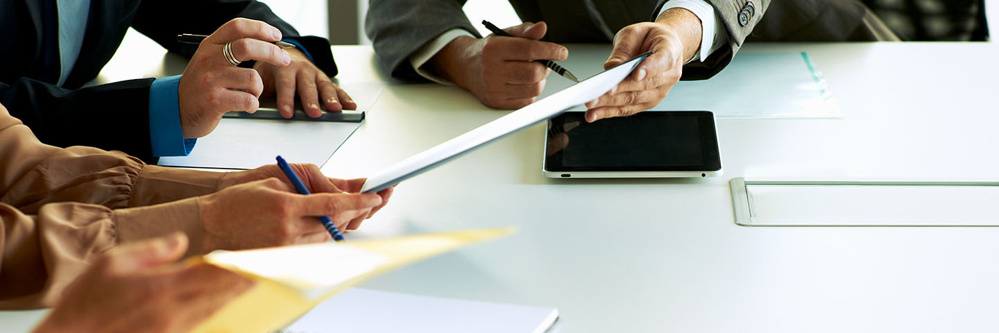 Close up photo of hands holding a tablet device.