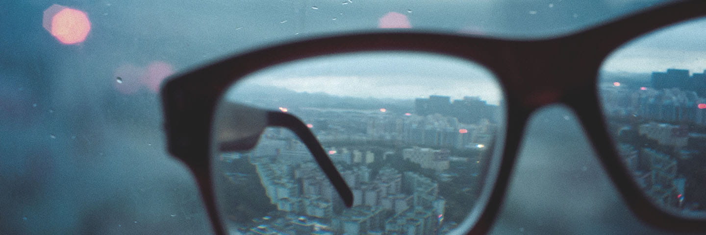 Looking through glasses at city.