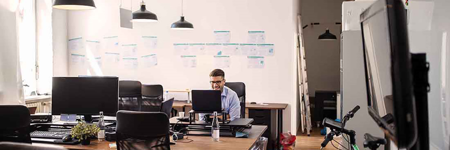 Business professional sitting at their computer in an office setting.