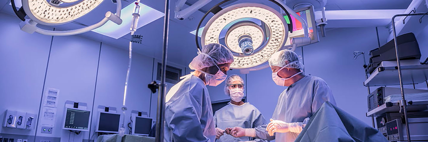 Three doctors in an operating room.