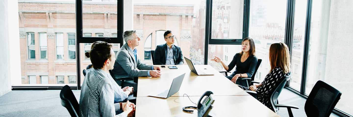 Financial advisors meeting in a boardroom.