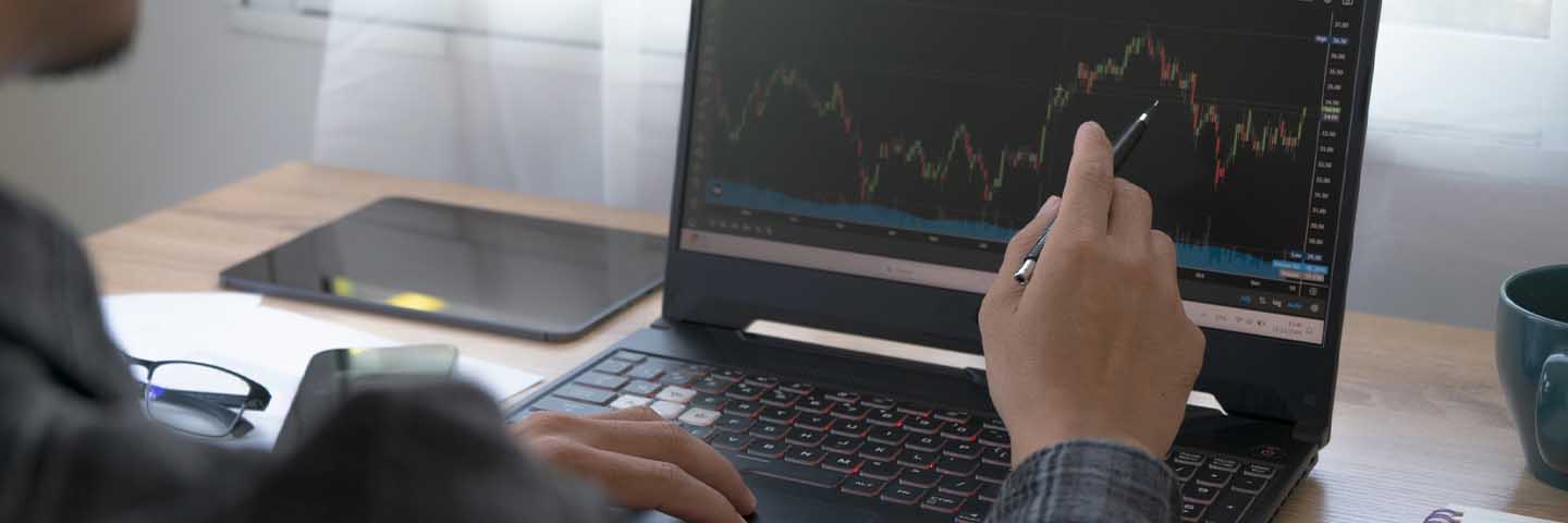 Close-up view of hands next to a laptop computer