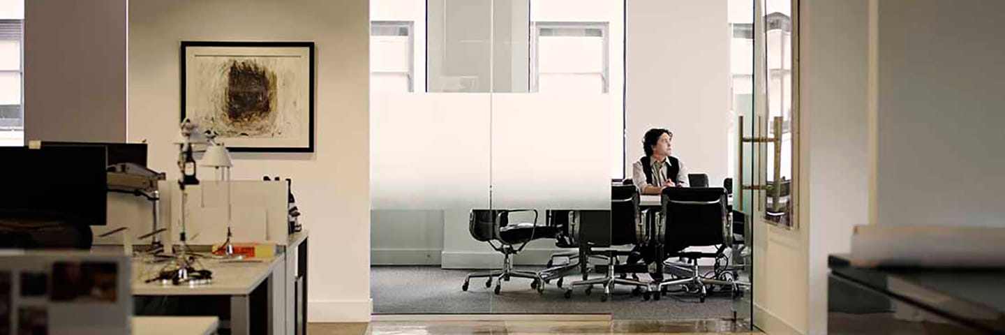 Business professional sitting in their private office.