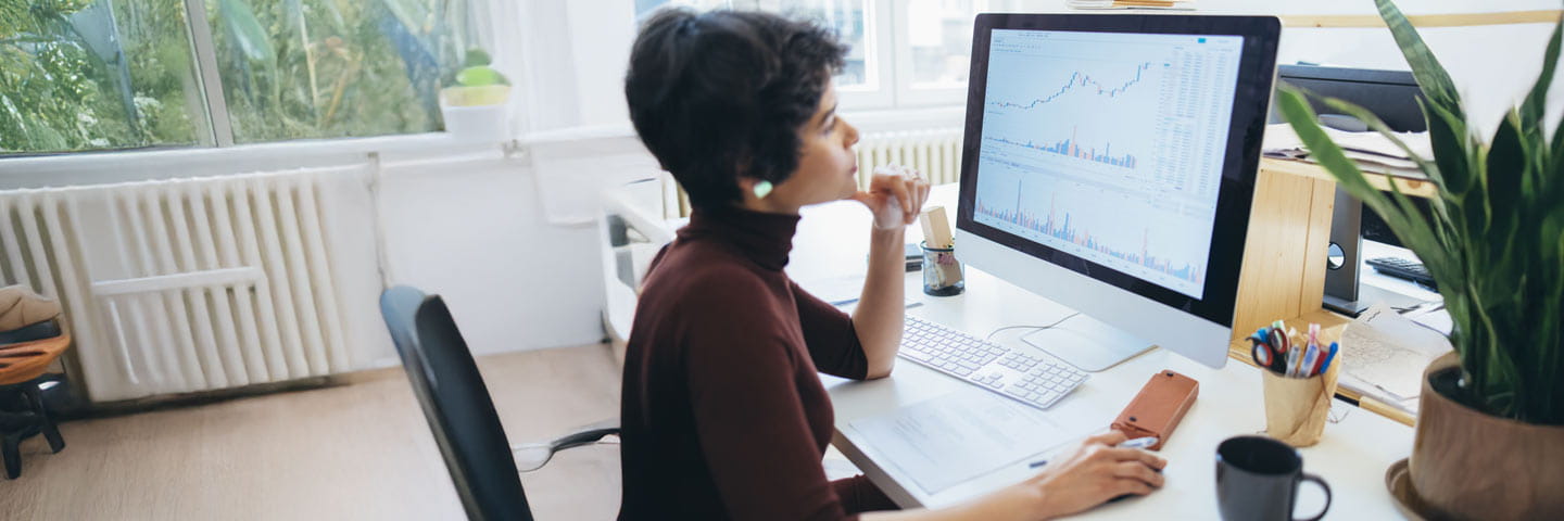 Business professional looking at chart data on their computer