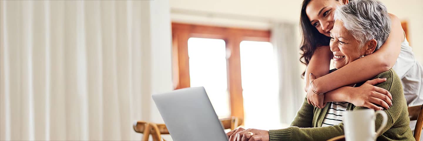 Grandparent hugging their child.