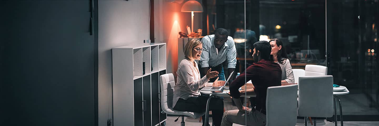 Group of coworkers talking in a conference room.
