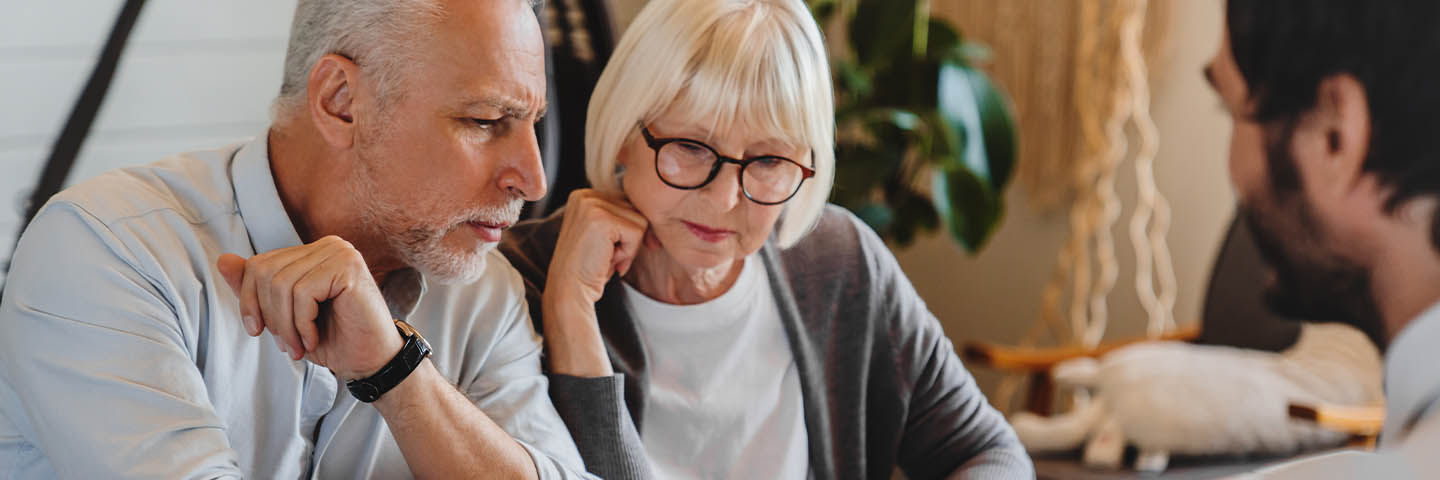 Elderly couple meeting with their financial advisor
