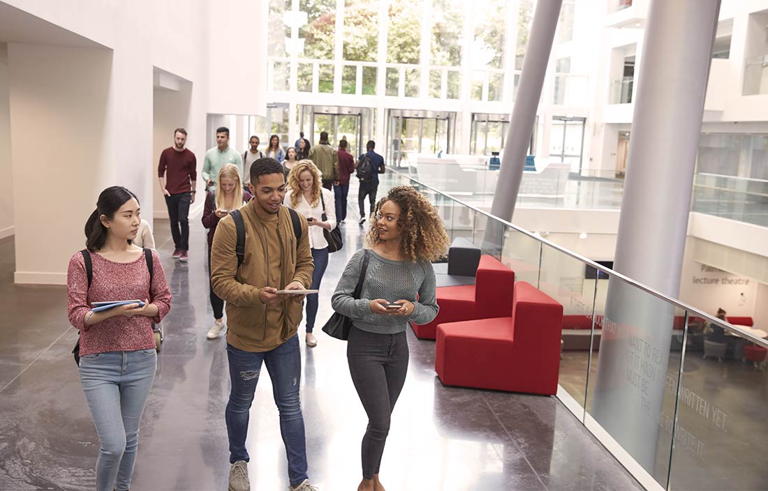 College students walking smiling and talking.