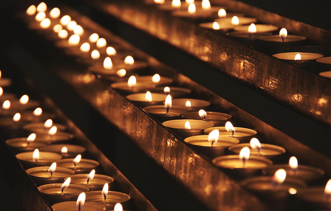 Close-up view of candles with a flame.