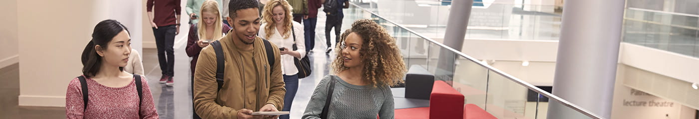 College students walking smiling and talking.