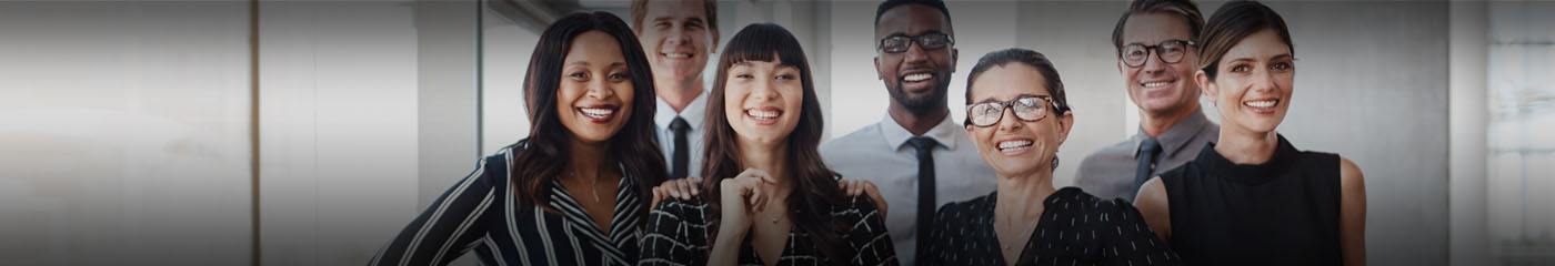 A diverse group of business professionals smiling.