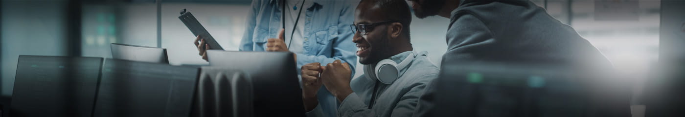 IT professional celebrating a small win at their desk.