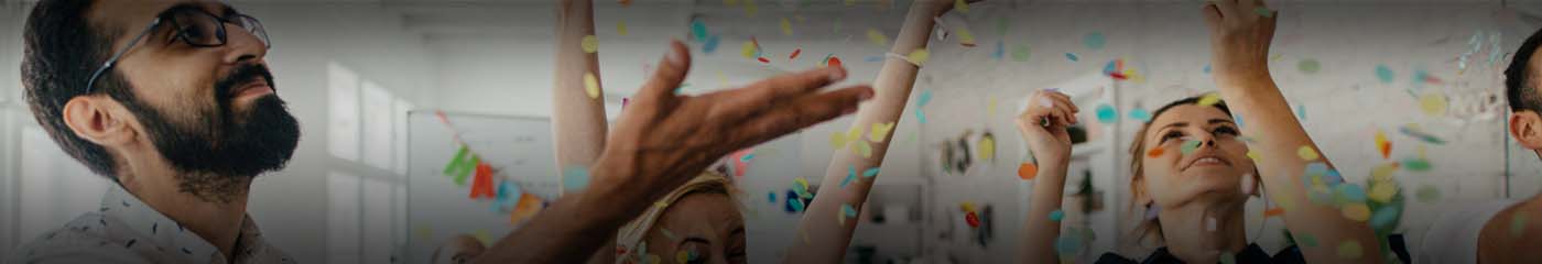People celebrating and throwing confetti in the air.