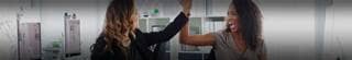 Two business professionals giving each other a high five.