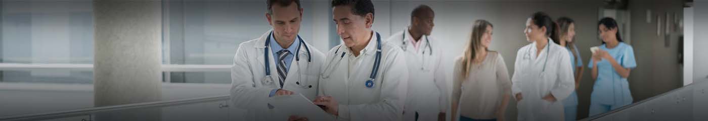 Doctors standing together talking.