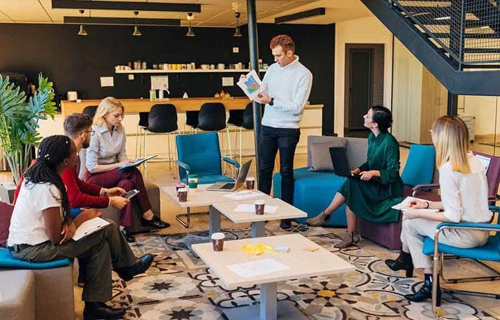 Group of business professionals gathered in a meeting discussing risk management.