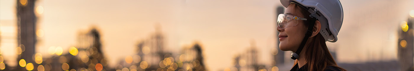 Construction worker in hard hat looking out to the skyline.