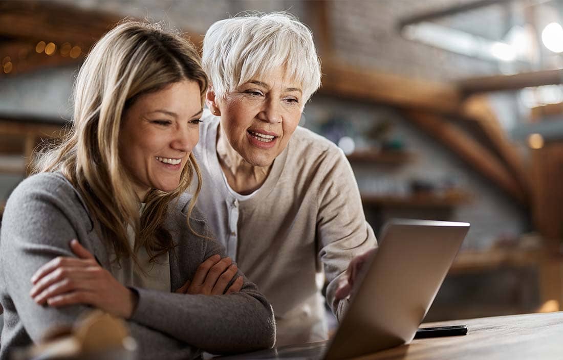 Two people smiling reading Plante Moran Wealth Management press room news.