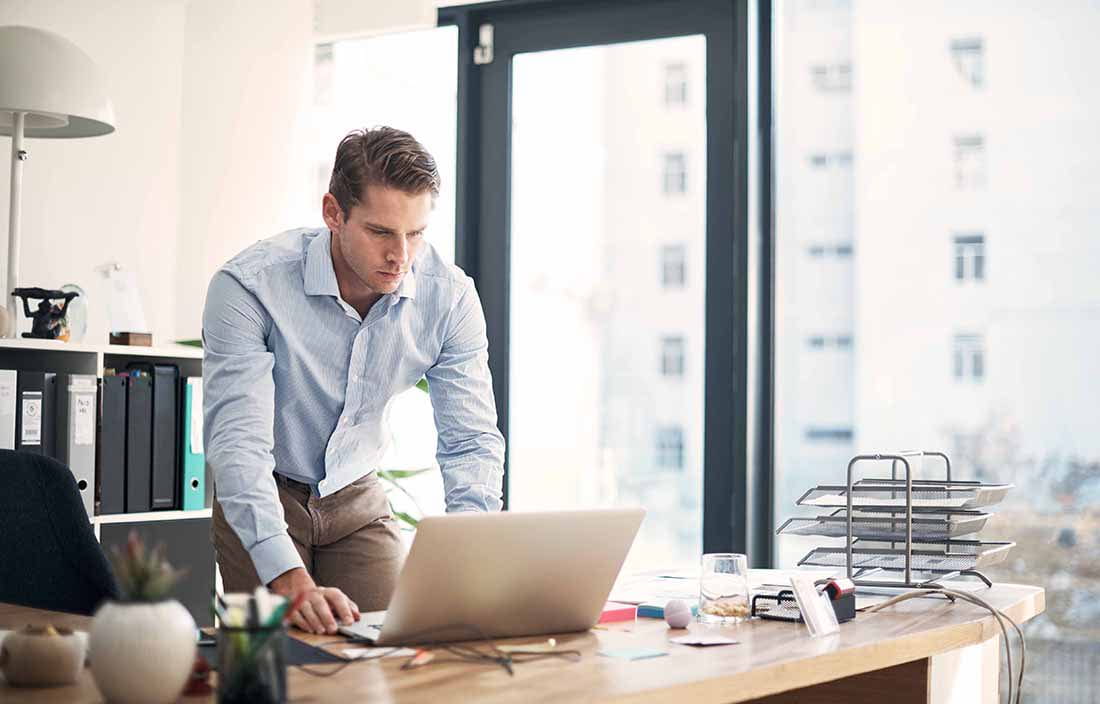 Adult at computer in office