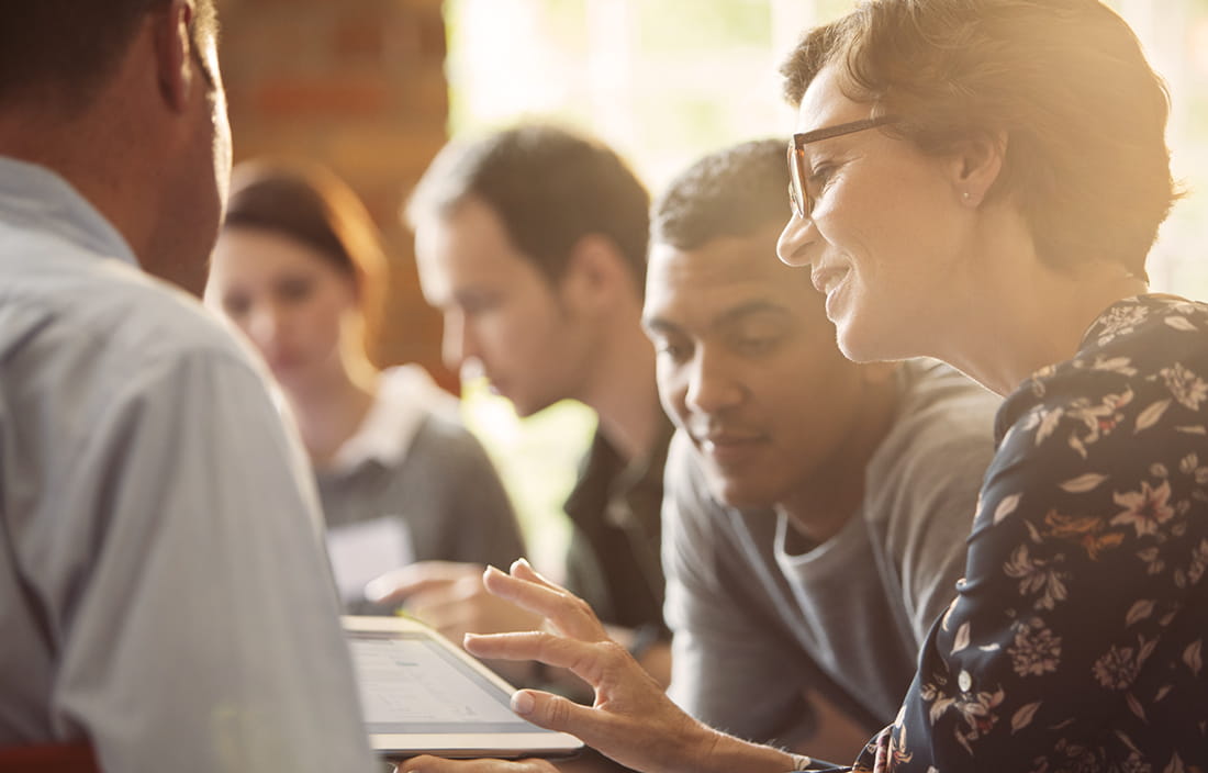 Picture of a group of people looking at a tablet