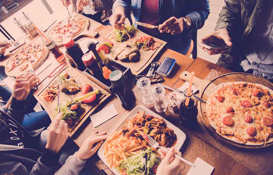 Image of people sitting around table enjoying dinner.