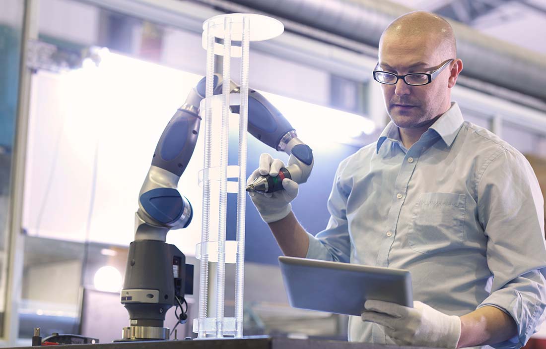 A man using a futuristic manufacturing machine.
