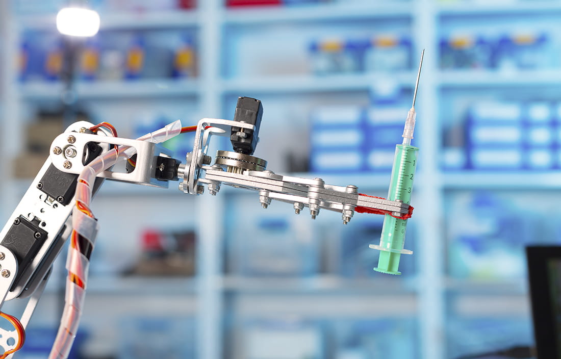 Robotic machine holding medical syringe.