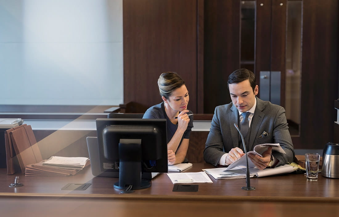 Business people looking over paperwork at a desk.