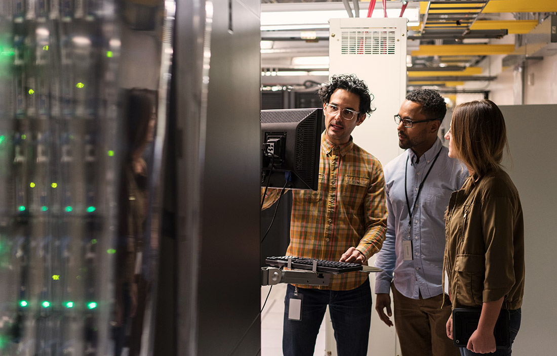 Cybersecurity professionals looking at a monitor together.