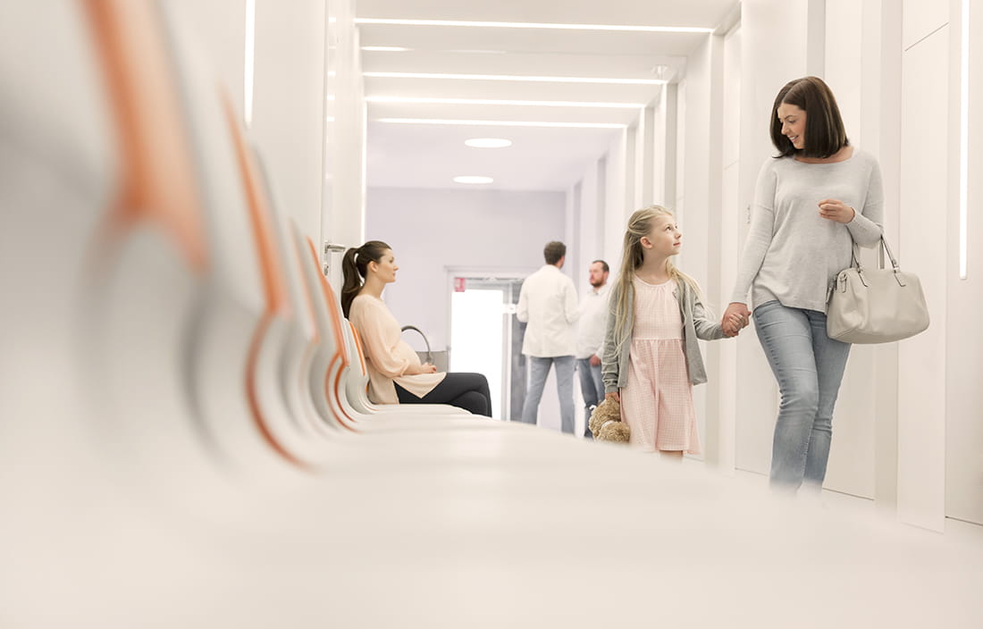 Mother and daughter walking in a hospital