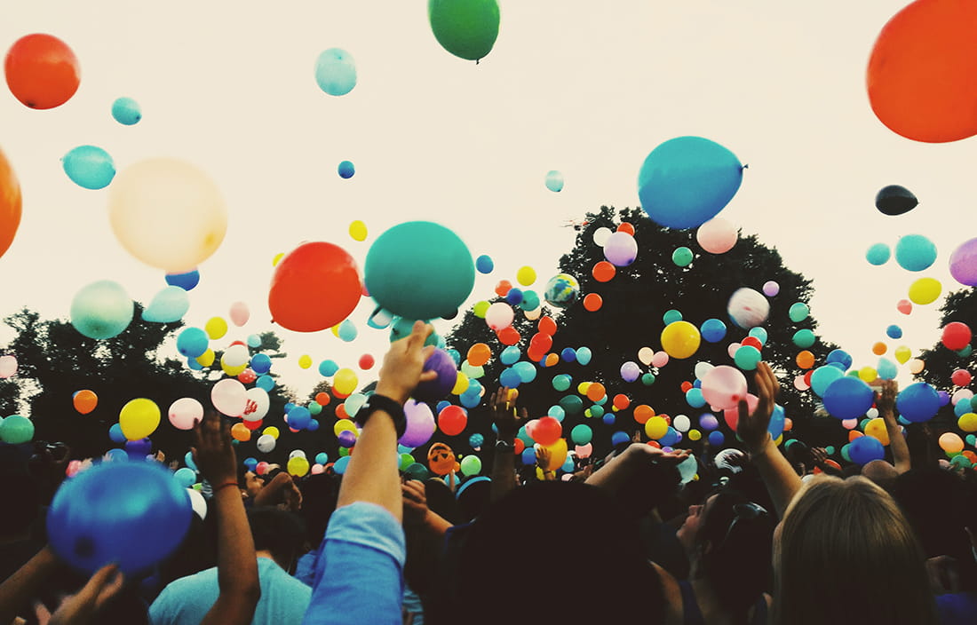 Image of people celebrating with balloons