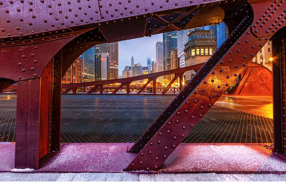Close-up photo of a red steel bridge.