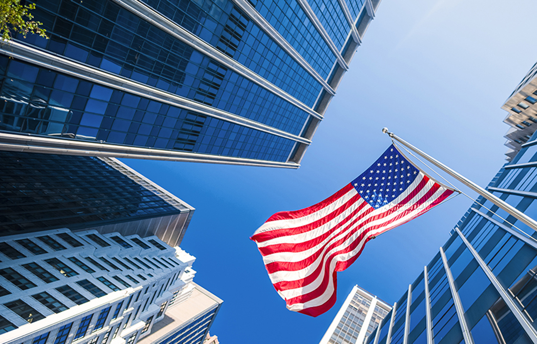 Image of American flag flying between buildings