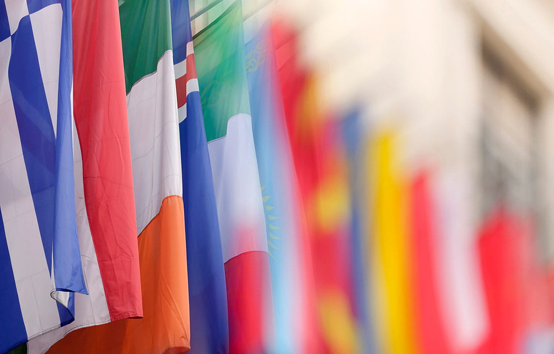 Close-up photo of various flags from different countries. 