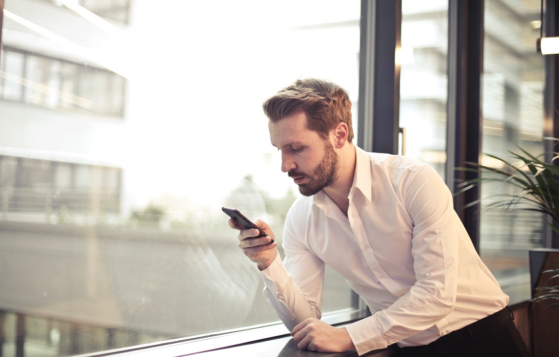 Image of man on phone at window