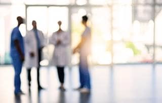 A picture of lab technicians talking in a lobby.