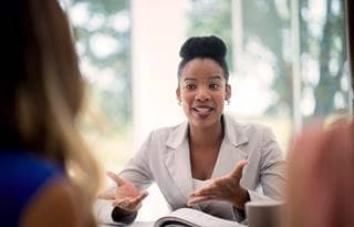 Woman discussing interal controls and financial controls with colleagues