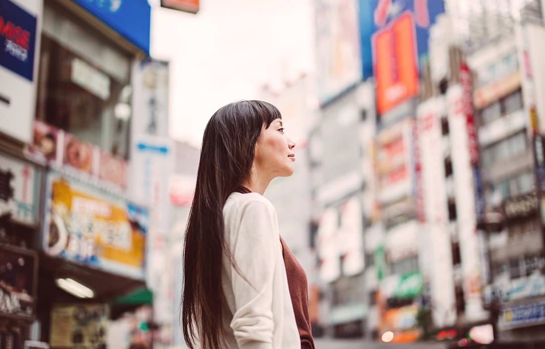 Image of woman standing in a city center