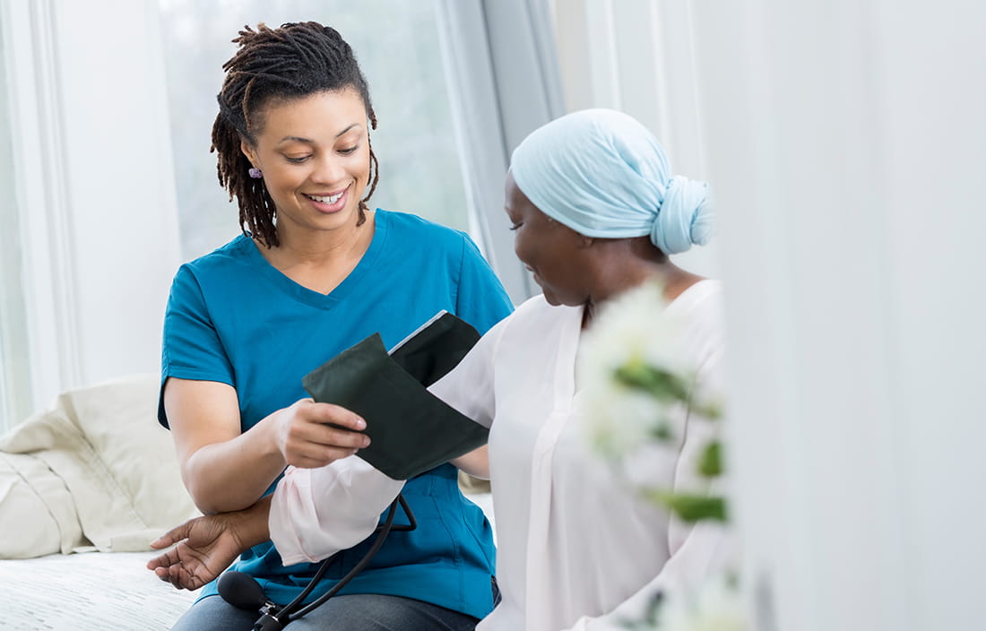Image of nurse taking patient's blood pressure, SNF PDPM financial impact assessment.