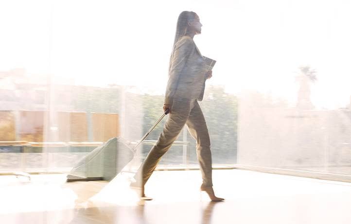 Person walking with documents 